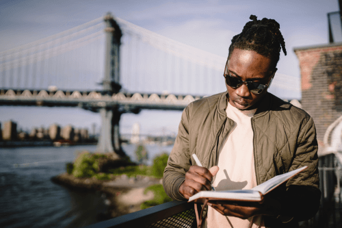 Man organizing his work schedule in a notebook