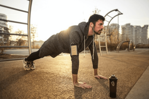 Man taking care of his health by doing press-ups