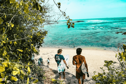 11 Best Countries for Digital Nomads in 2025 19 Travelers walking on the beach with surfboards