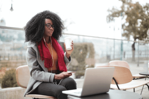 Woman browsing the internet on her laptop on WiFi