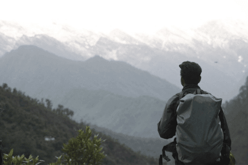 12 Best Backpacks for Traveling Asia in 2025 7 Best Backpacks for Traveling Around Asia - Man on a mountain