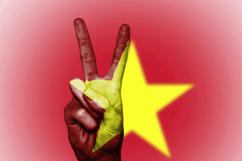 Vietnam flag with hand showing the peace sign to represent Vietnam being one of the best countries for digital workers