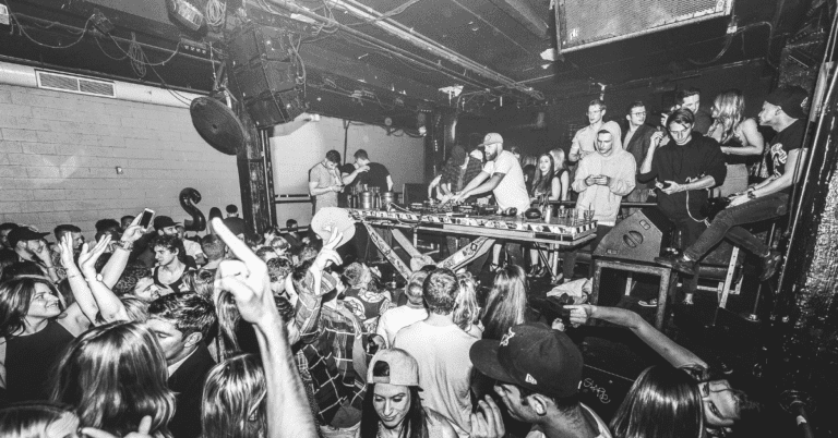 line array speakers in a nightclub with a dj